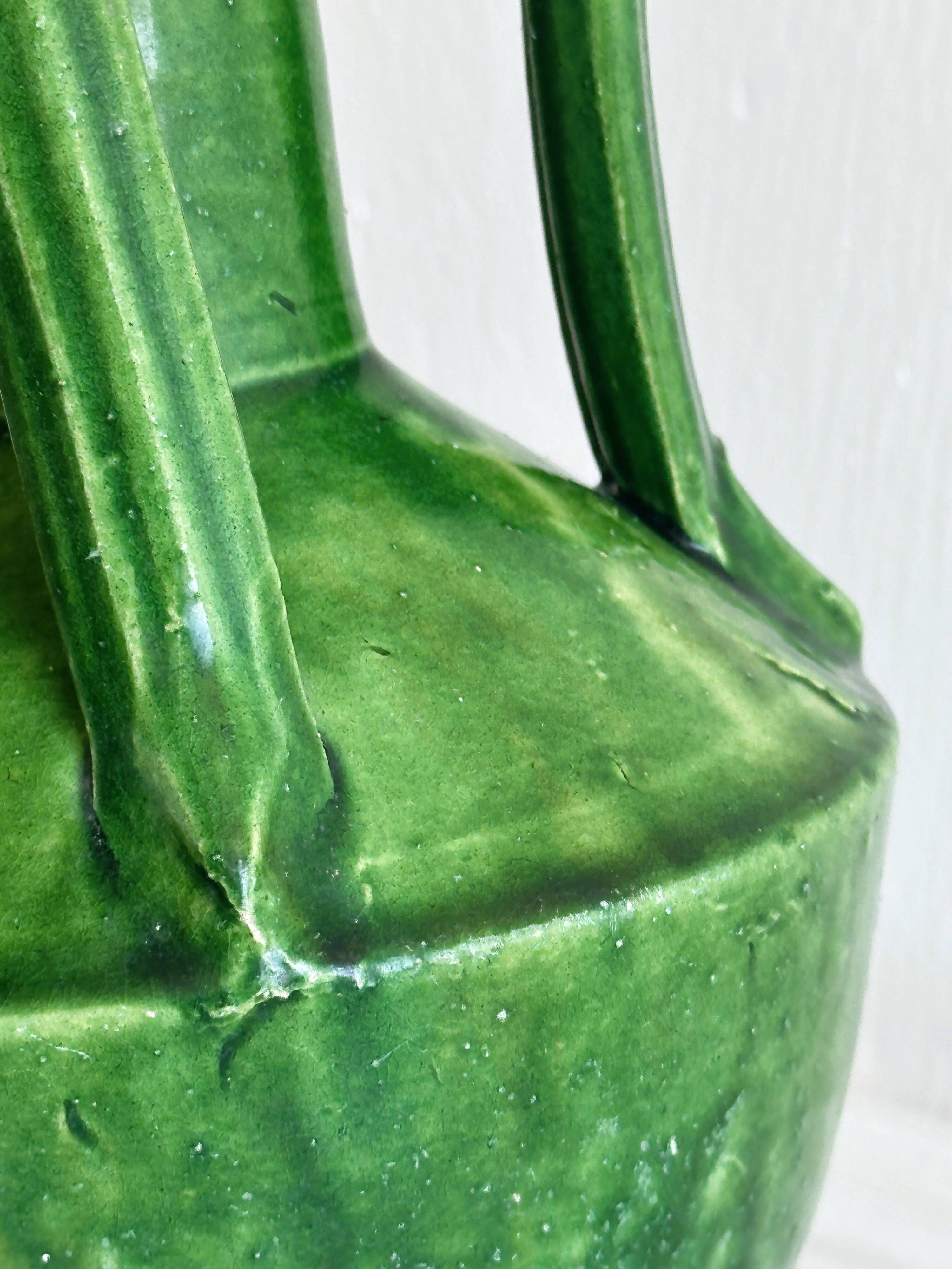 Pottery green ceramic vase with four handles.
