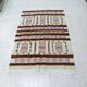 Handmade Berber kilim rug with multicoloured tribal motifs.