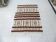 Handmade Berber kilim rug with multicoloured tribal motifs.