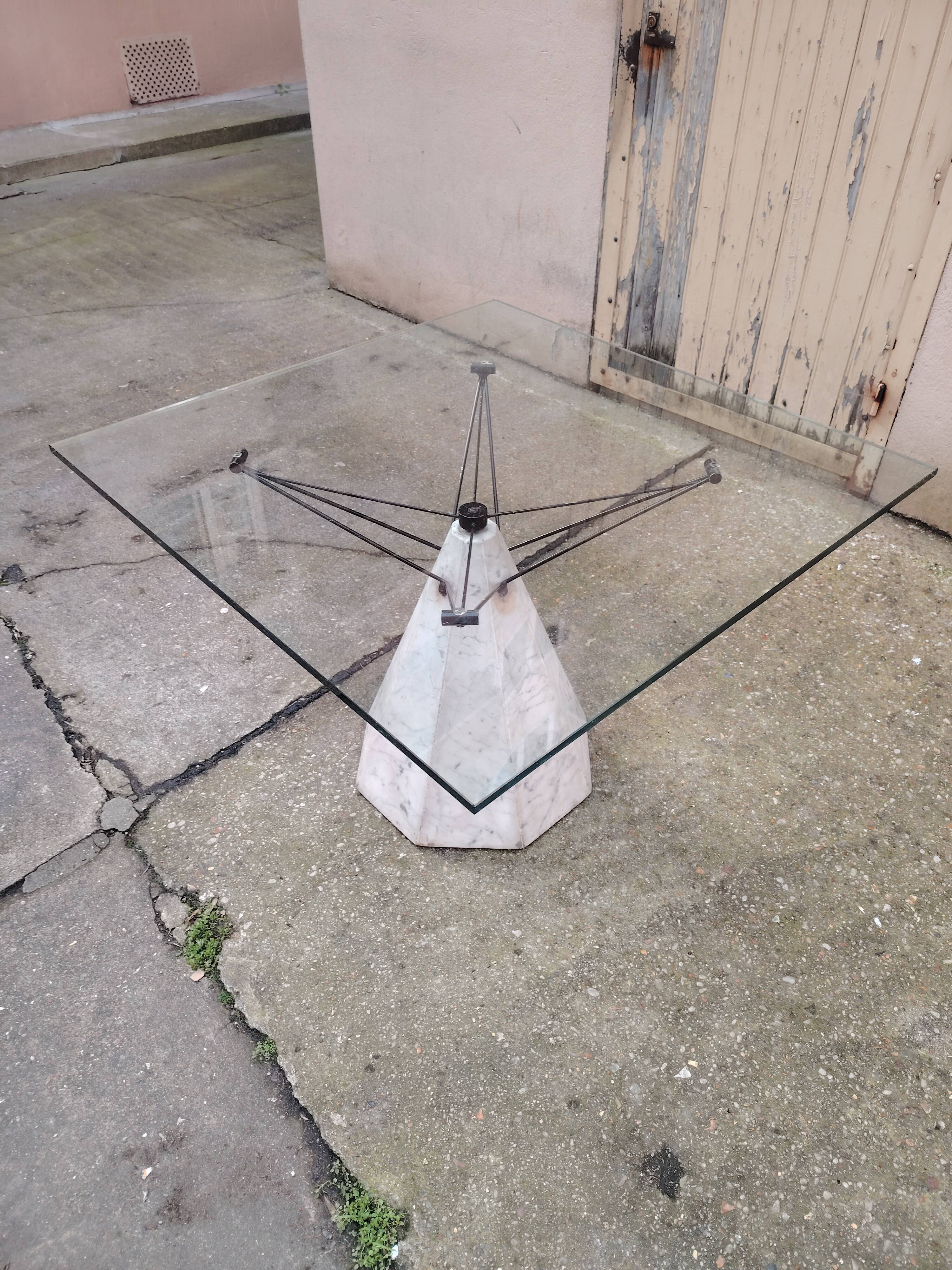 1980s table with a marble and steel base and a square glass top.