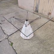 1980s table with a marble and steel base and a square glass top.