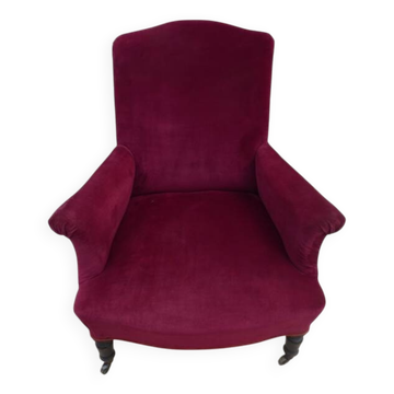 Blackened wooden bergère on wheels, Napoleon III period, upholstered in velvet.