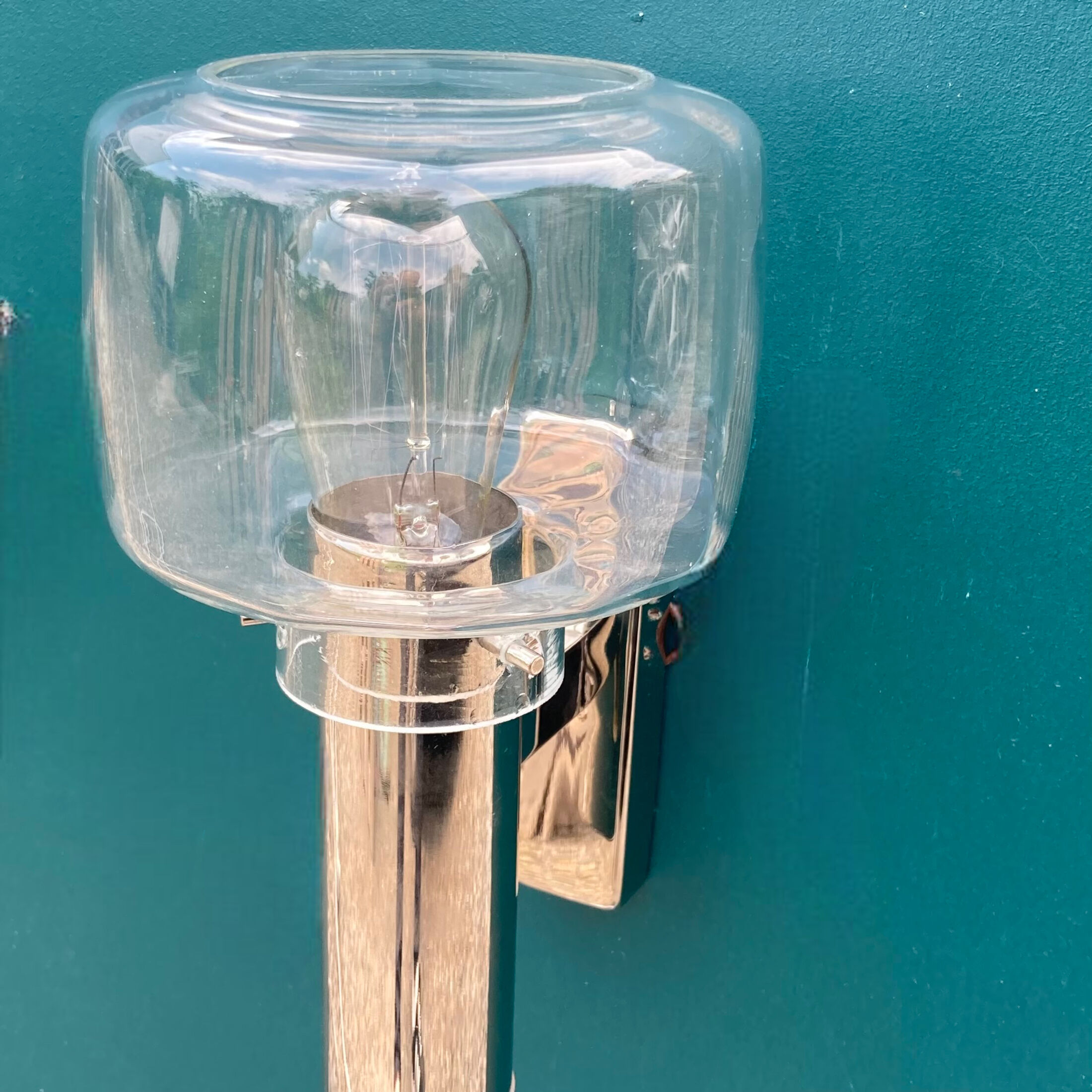 Wall lamp in stainless steel and globe in transparent glass