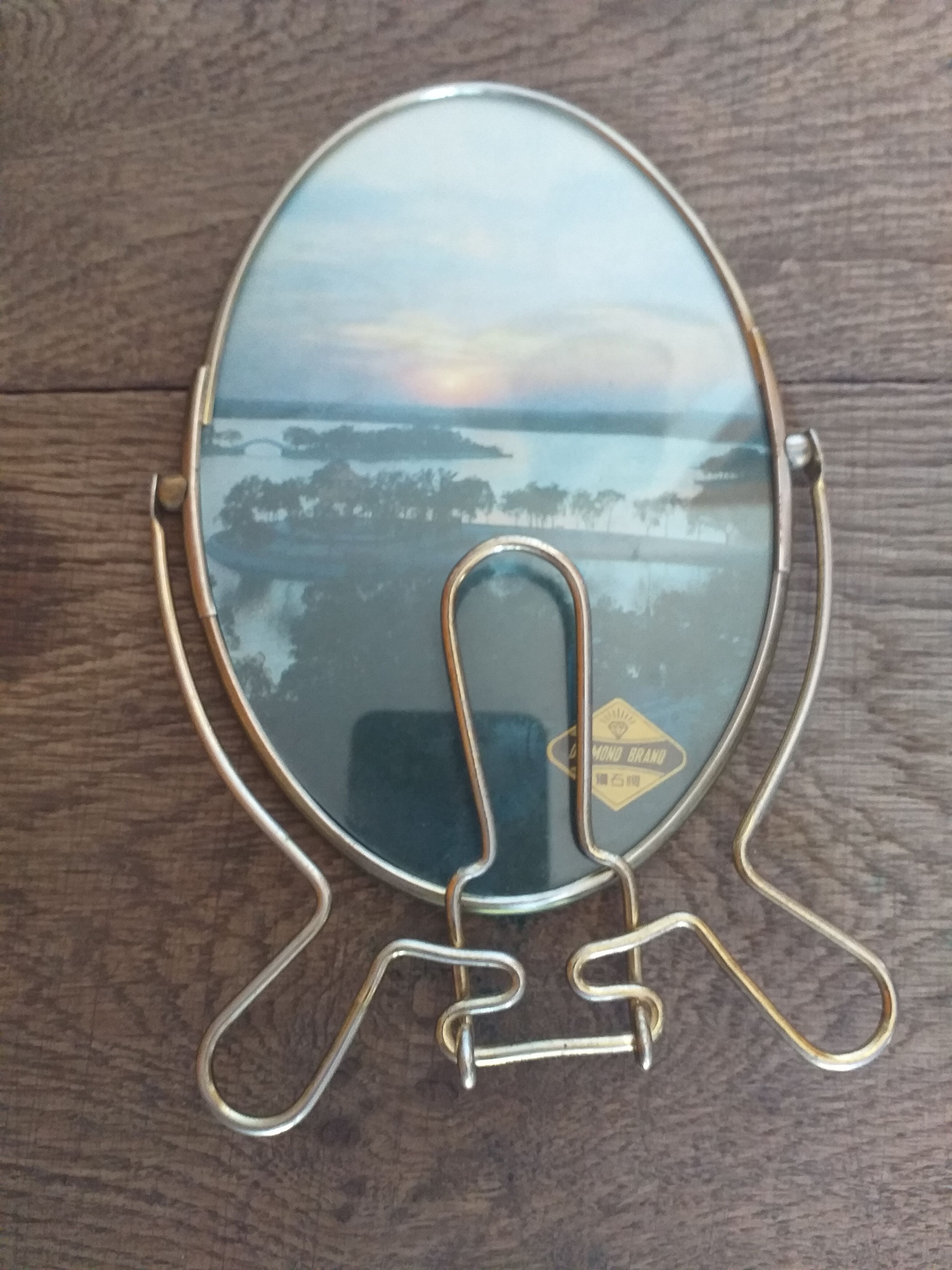 Vintage oval mirror on suspended stand
