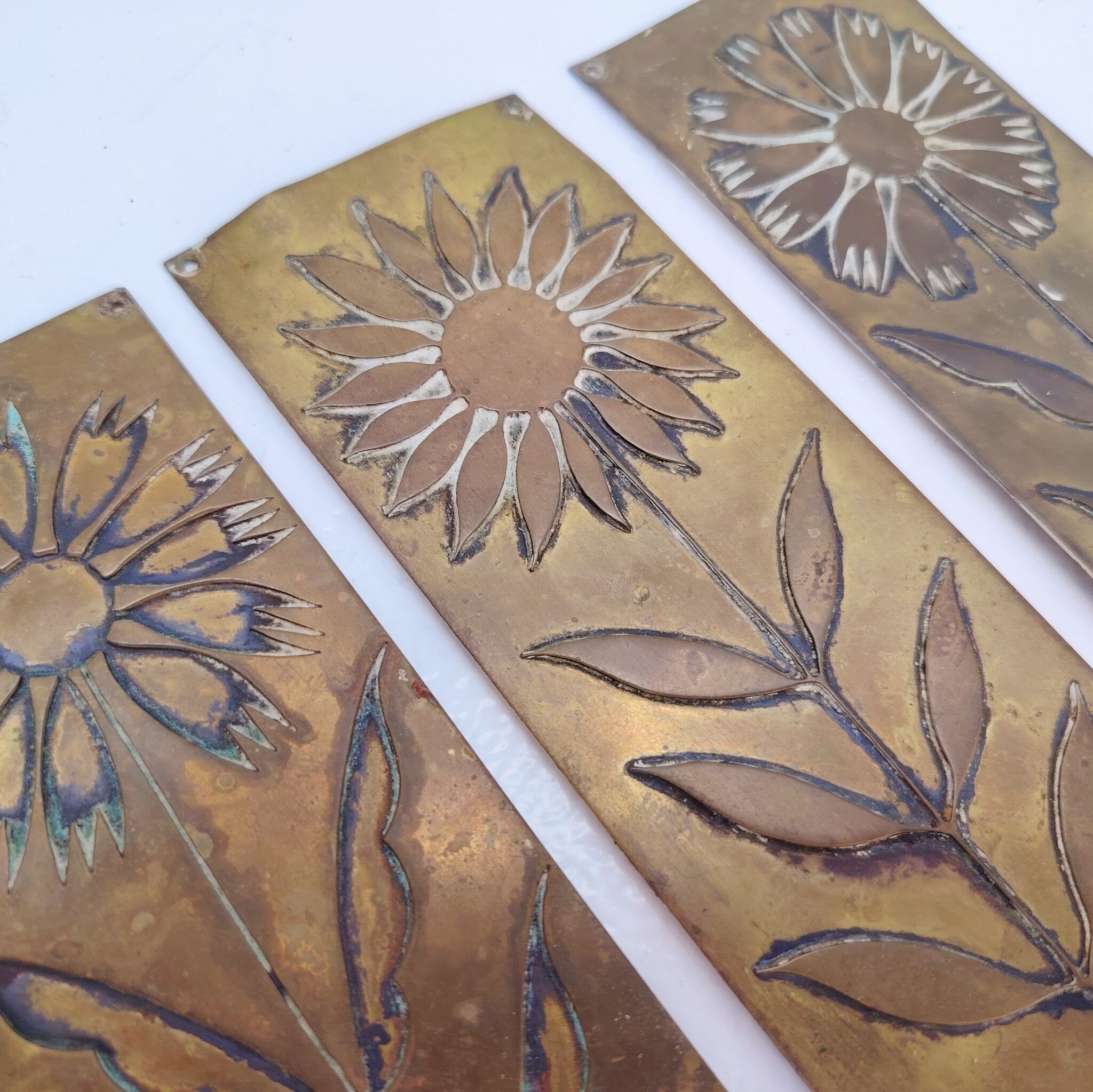 Six cleanliness plaques, flower design, brass.