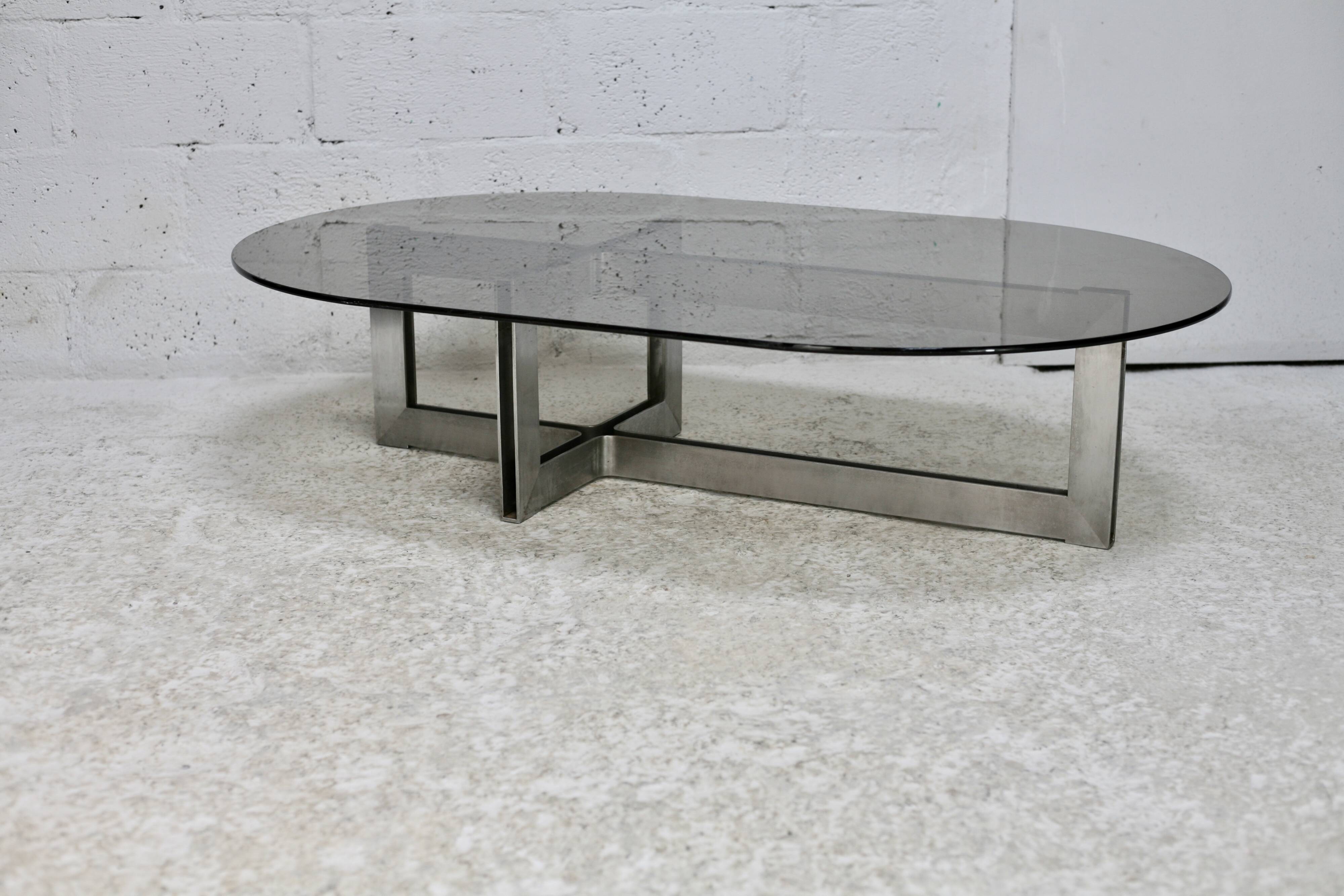 Coffee table with steel base and smoked glass slab. Circa 197
