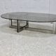 Coffee table with steel base and smoked glass slab. Circa 197