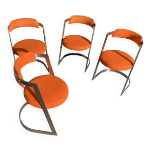 Quatre fauteuils inox