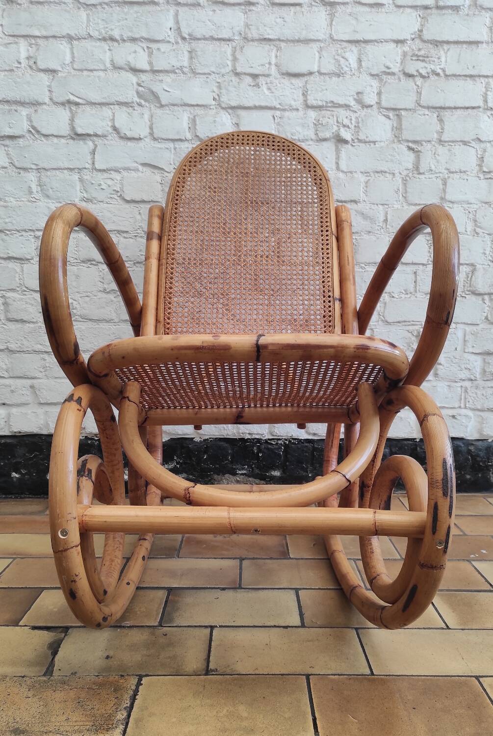 Vintage rocking chair in rattan and cane.