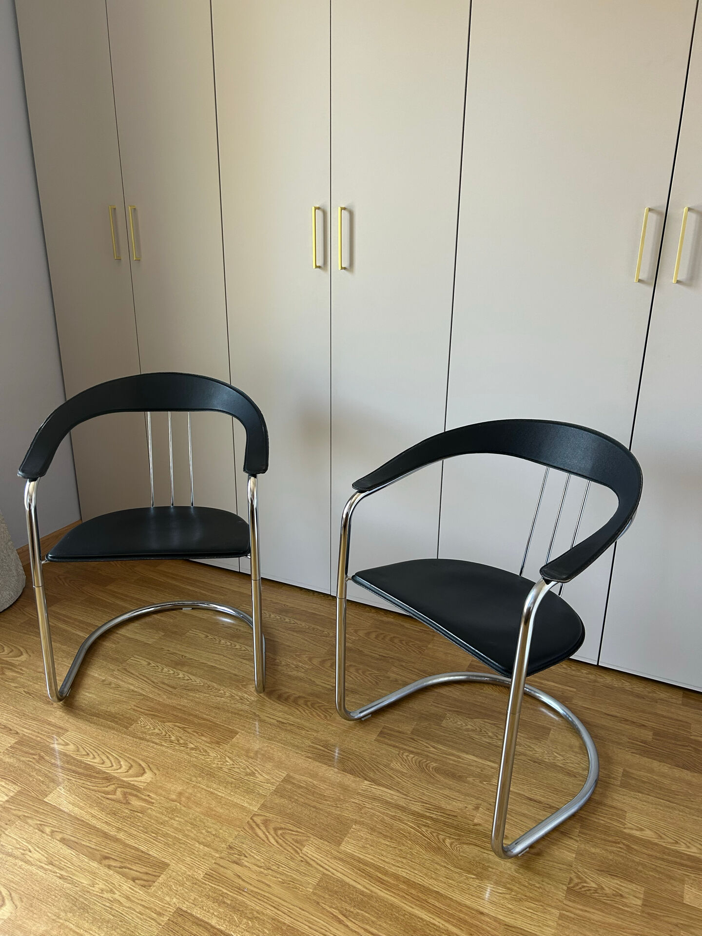Space Age chairs in black leather and chrome metal