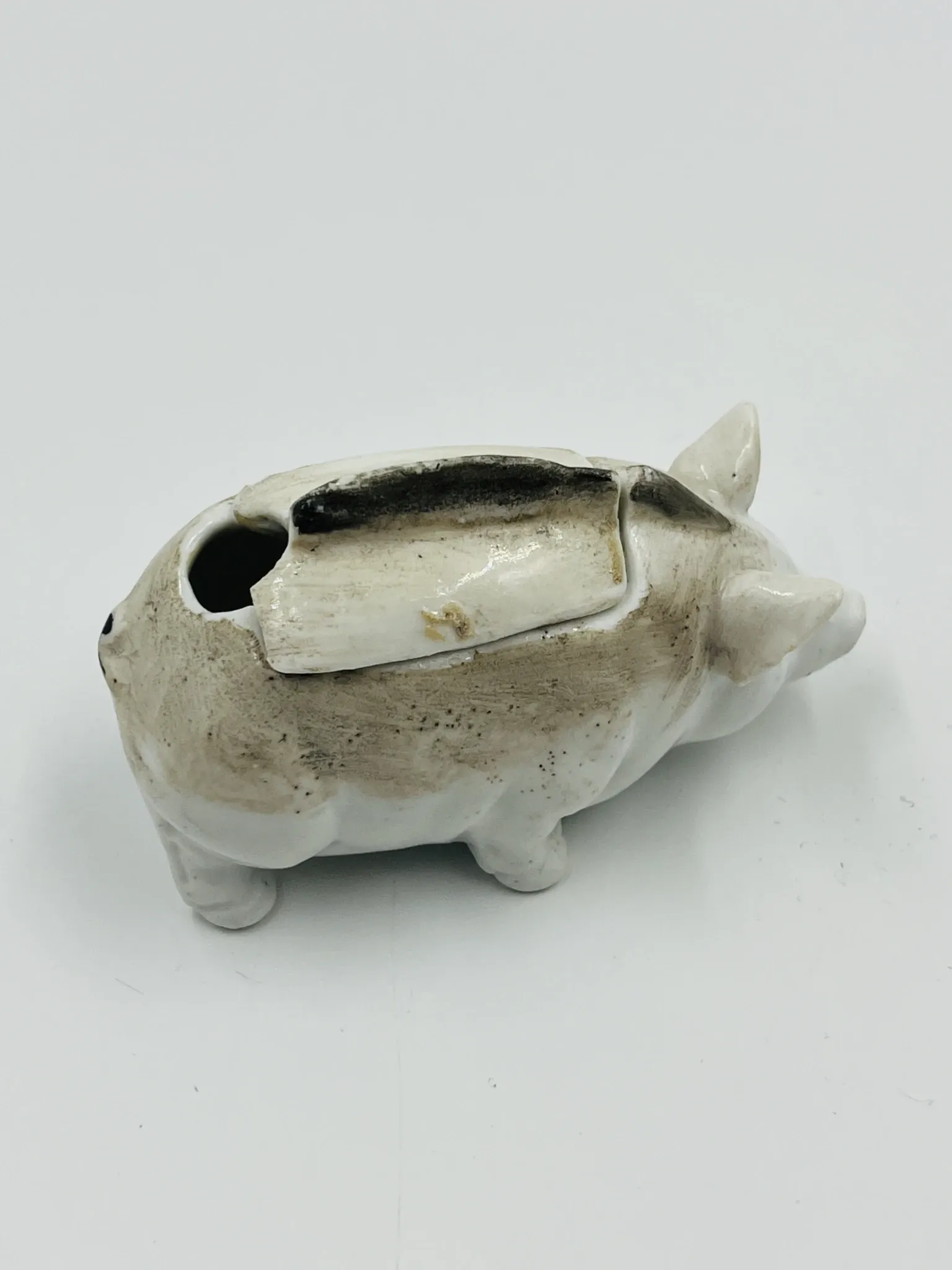 Vintage mustard pot in porcelain shaped like a pig.