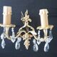 Pair of gilt bronze wall sconces with crystal pendants.