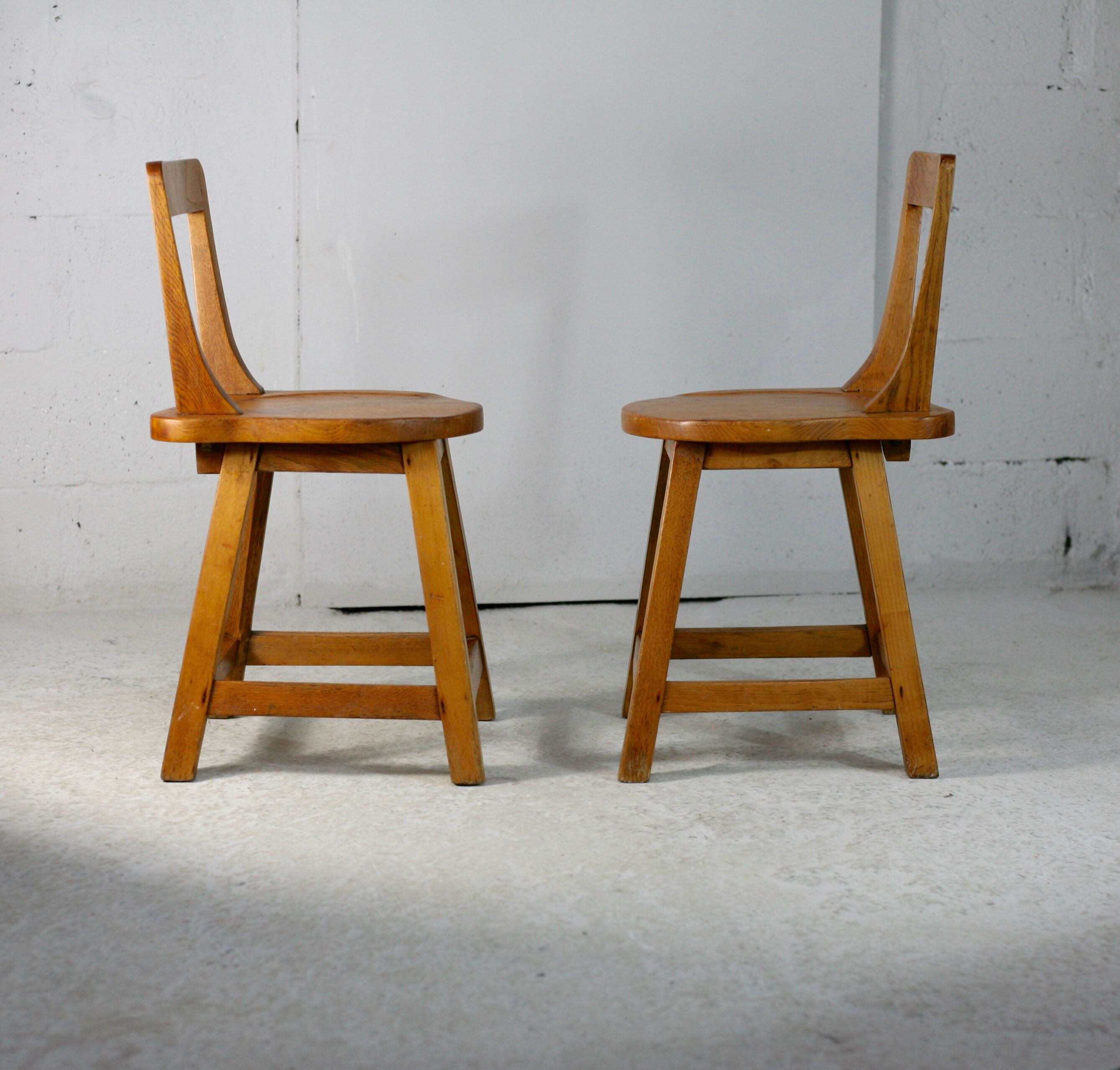 Pair of brutalist wooden back stools. France, circa 1960