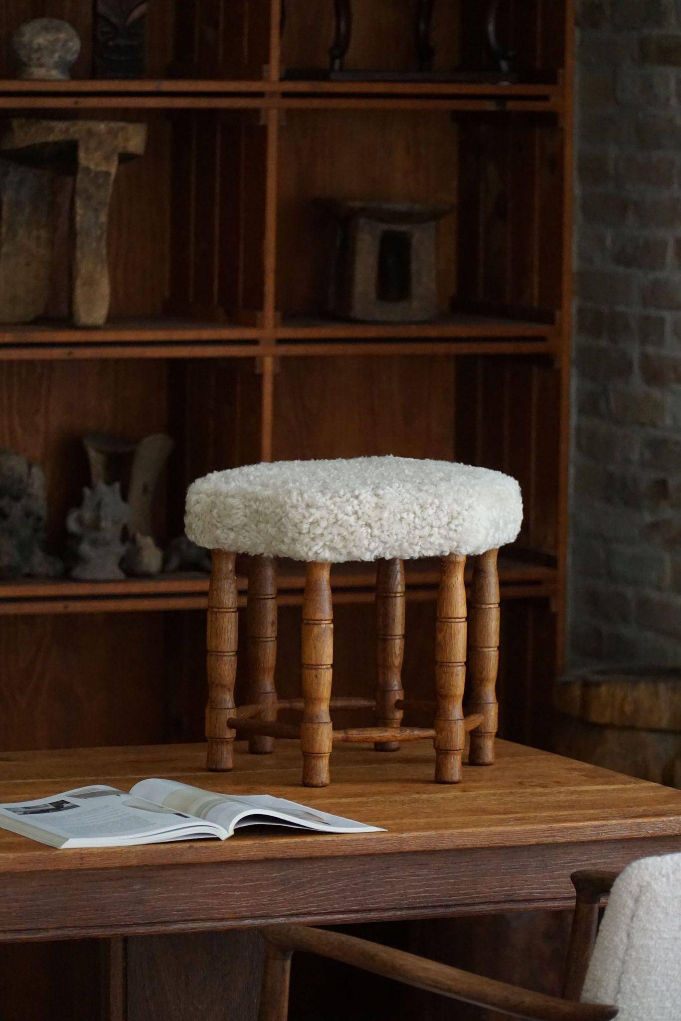 Modern Danish, a hexagonal oak stool, seat reupholstered in lambswool, 1950s.