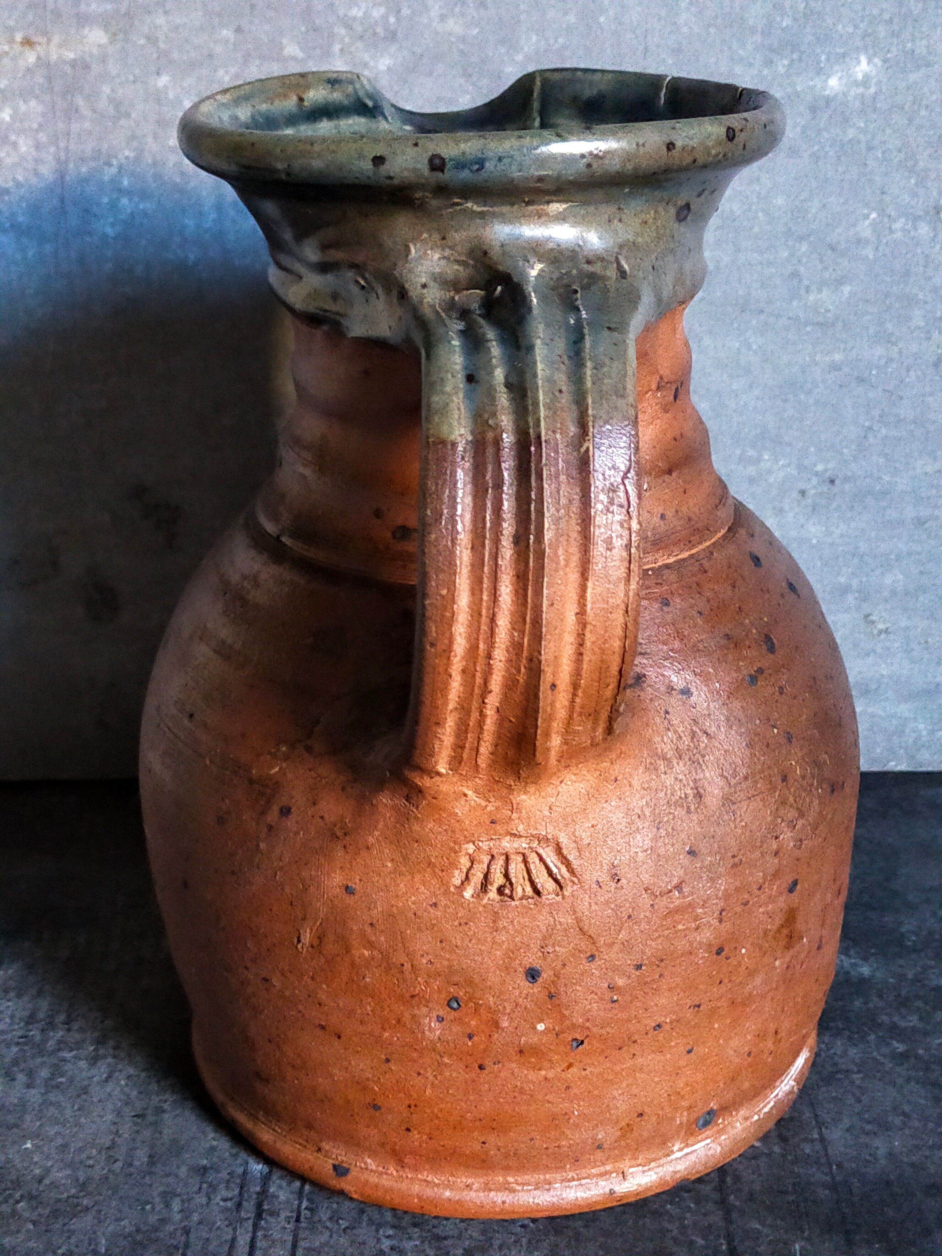 Pitcher traditional pottery Folk art in old enamelled sandstone