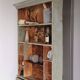 Craft cabinet with drawers with a very old tobacco advertisement in the background