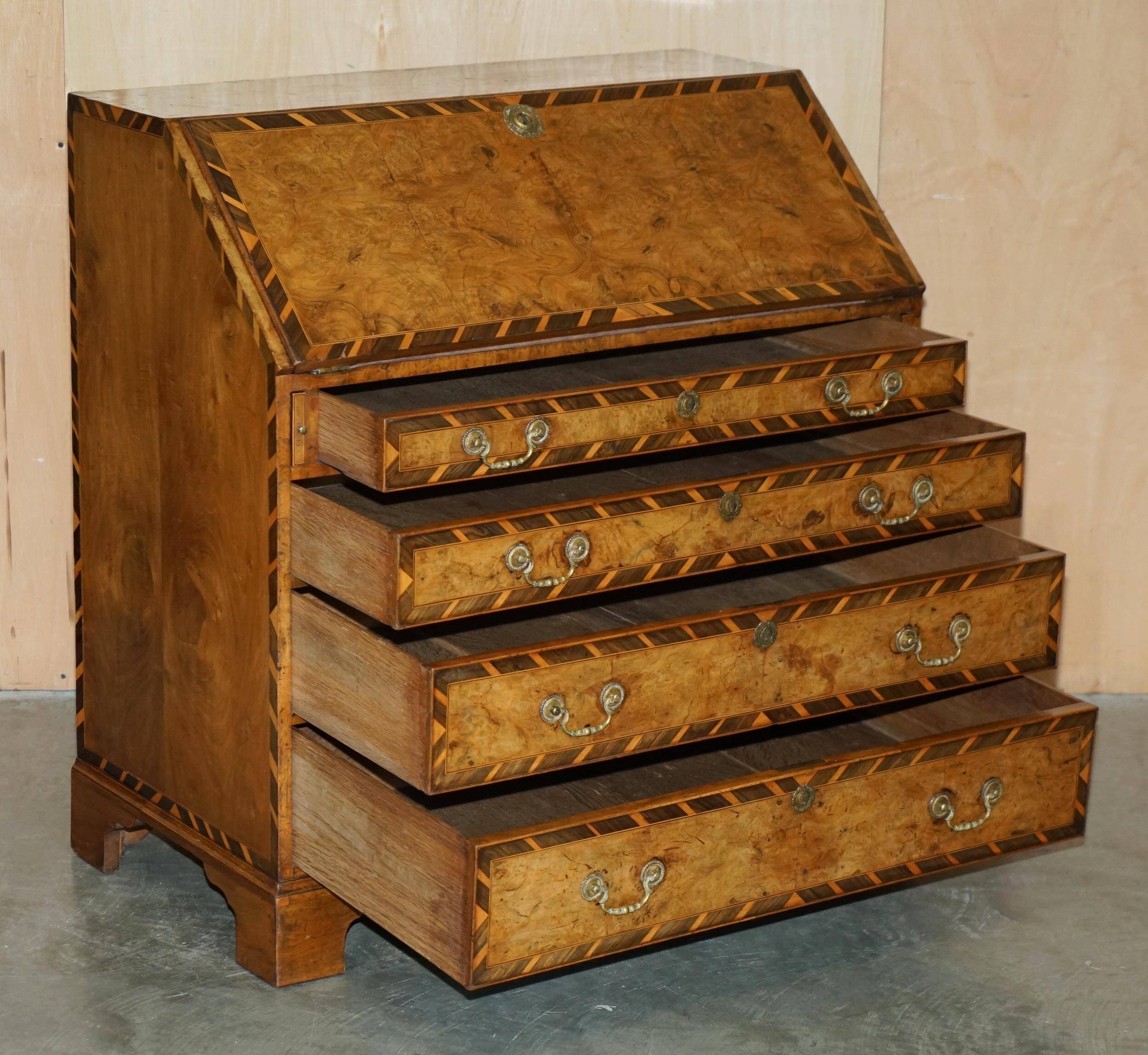 Antique George II bureau from 1740 in walnut, rosewood, and leather.