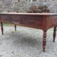 Old farmhouse table with cherry and chestnut panels with 3 drawers.