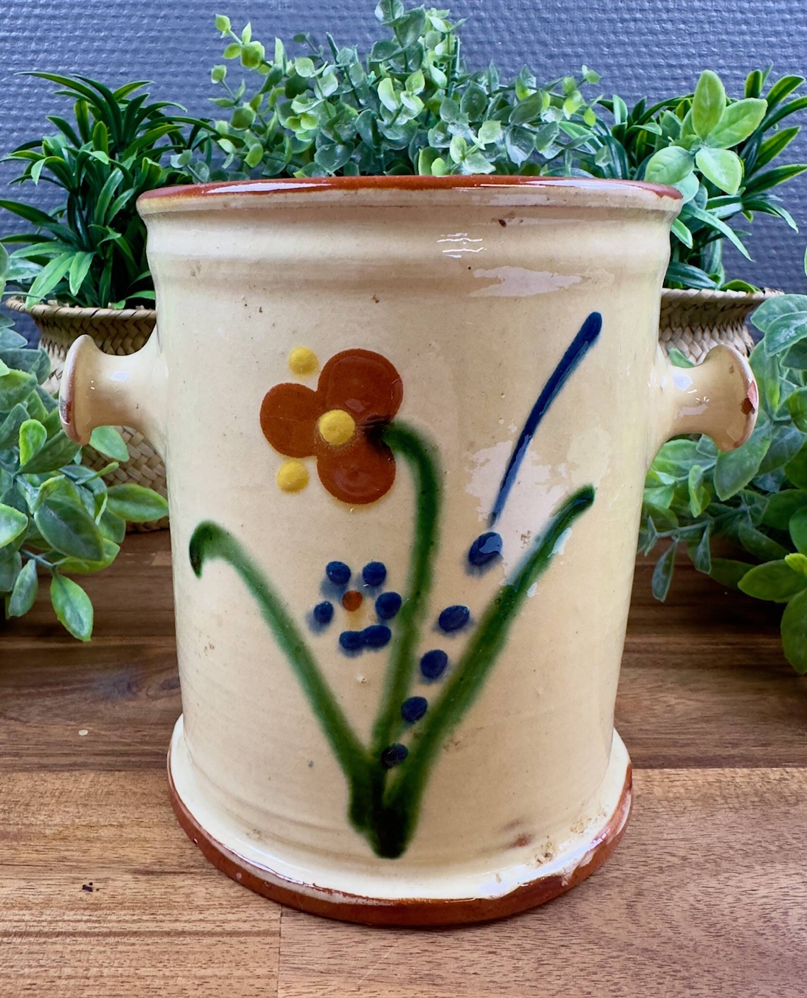 Antique ceramic pot with hand-painted floral decoration.