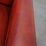 Set of 2 red-colored design armchairs made of sheepskin leather