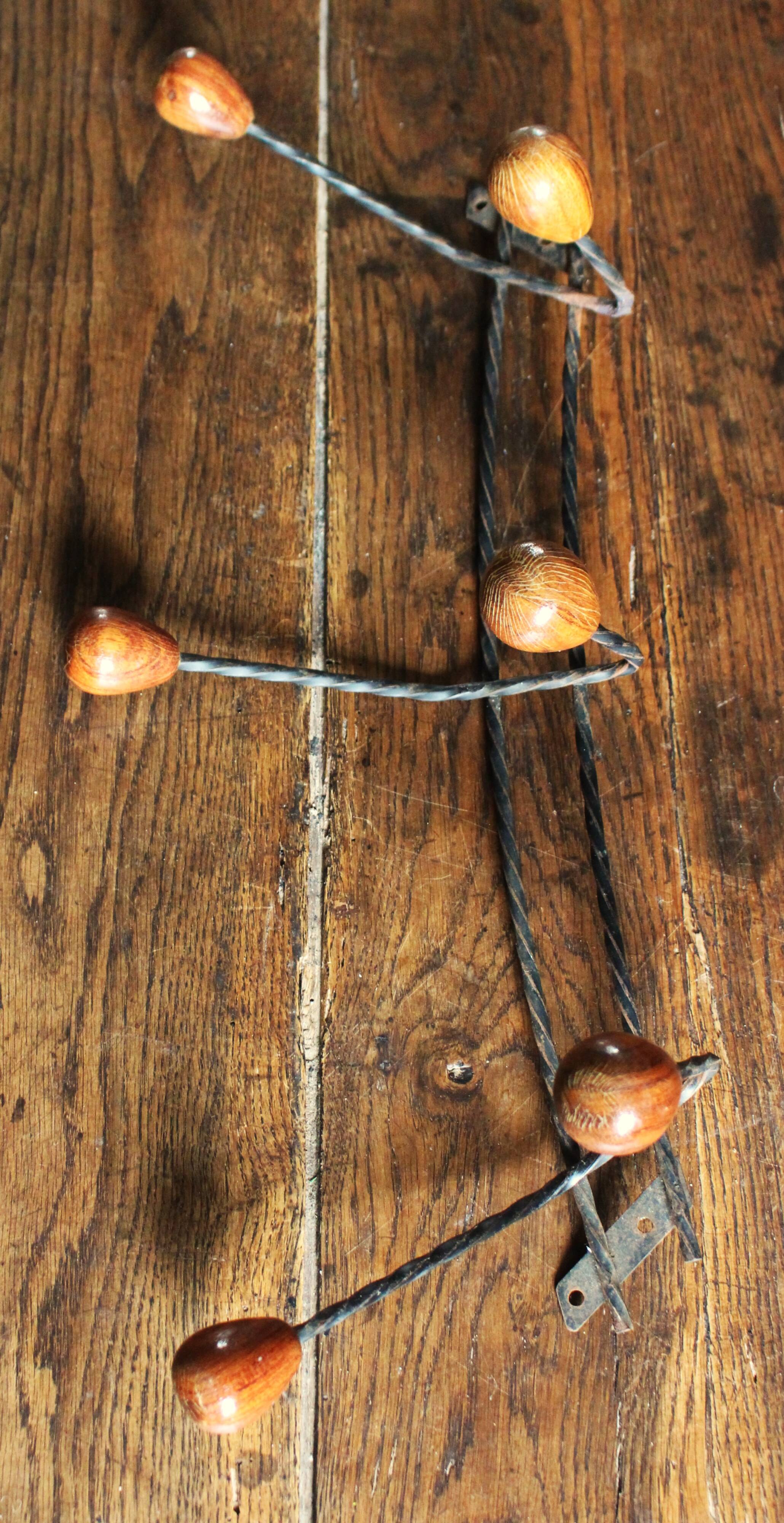Double wrought iron coat rack with 3 double wooden ball hooks