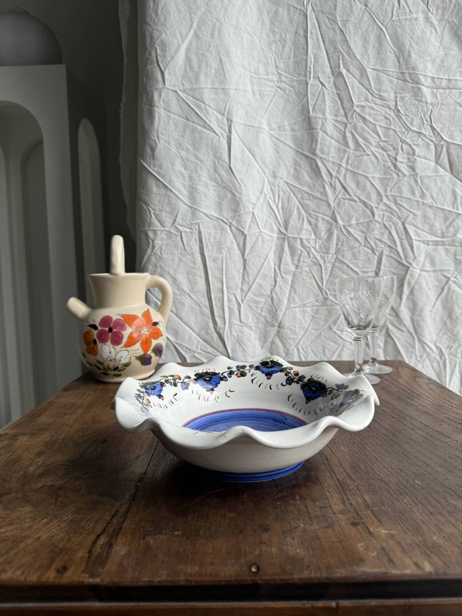 Small hand-painted earthenware salad bowl with garland of blue flowers, mark below