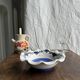 Small hand-painted earthenware salad bowl with garland of blue flowers, mark below