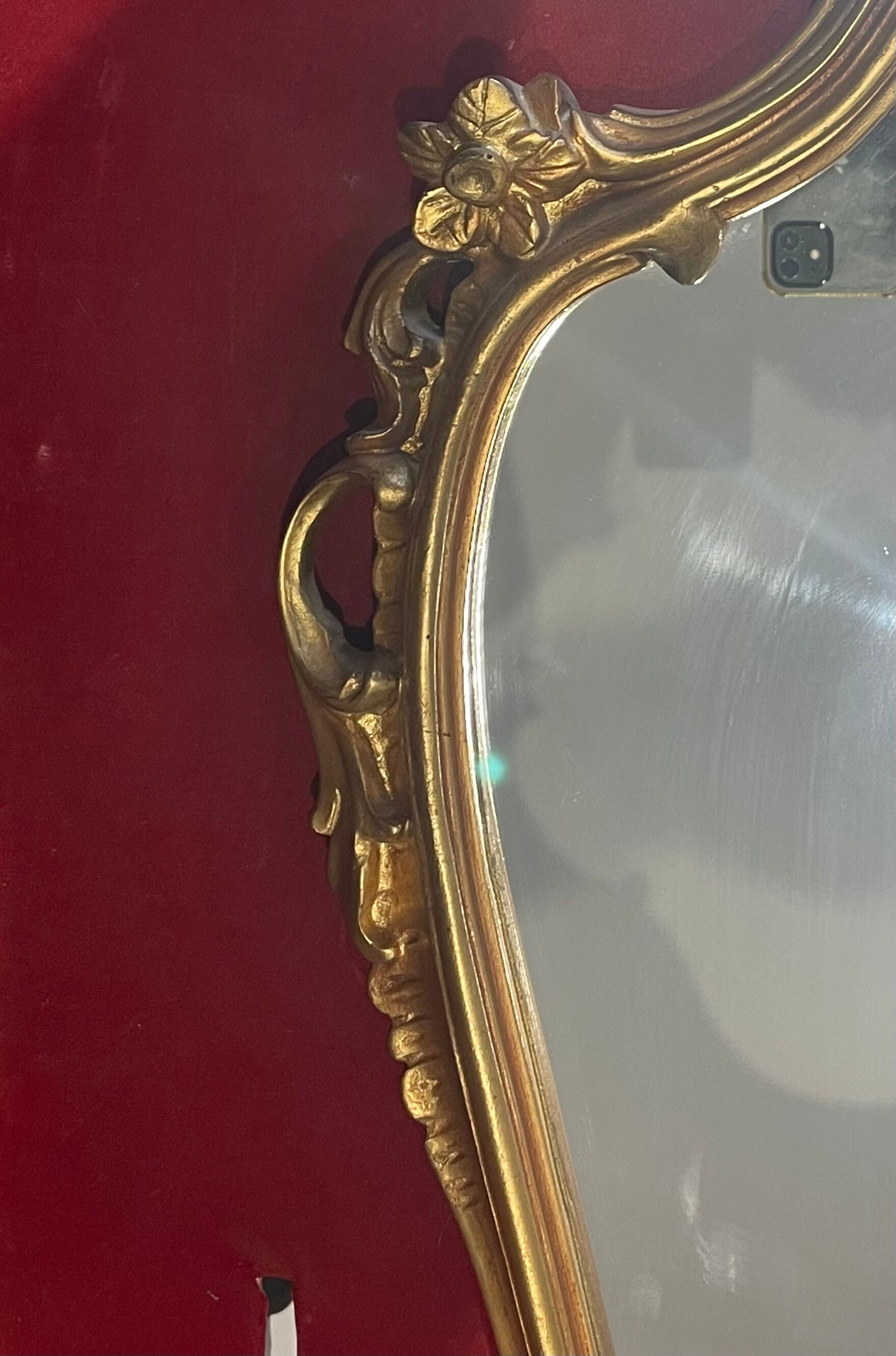 Louis XV Style wood and gilded stucco mirror with animated shape