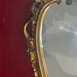 Louis XV Style wood and gilded stucco mirror with animated shape