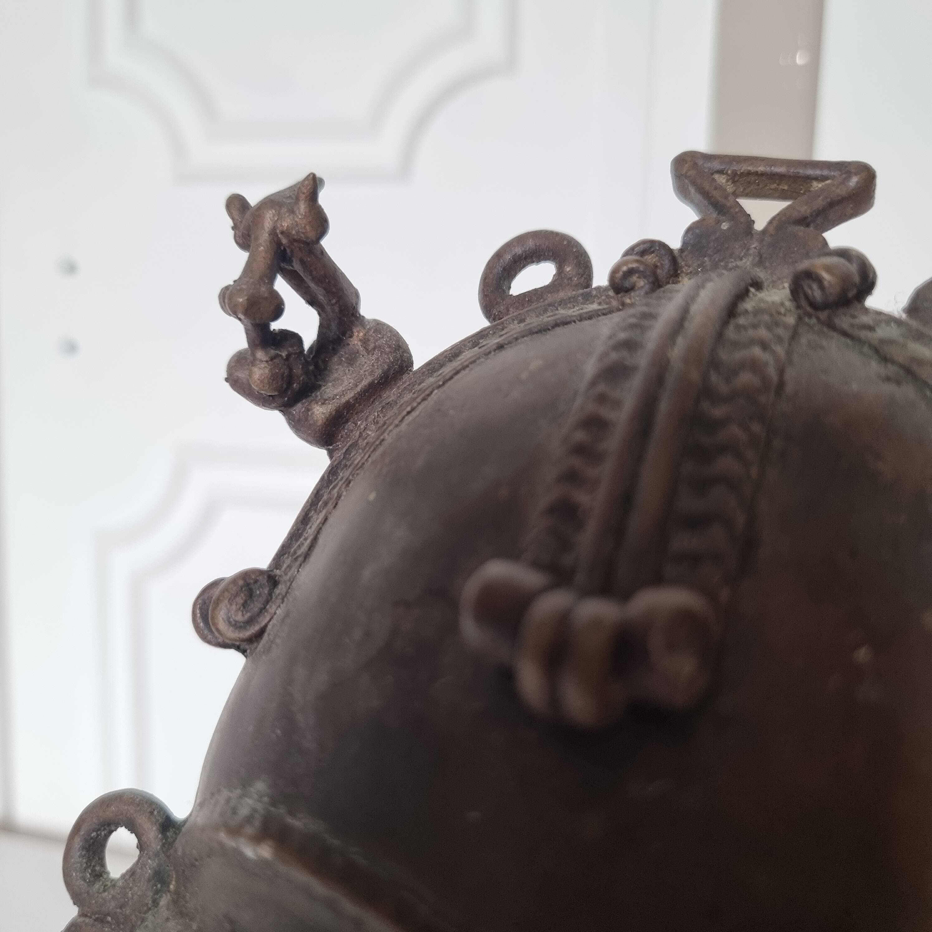 African bronze mask on pedestal, from Ivory Coast, dating
