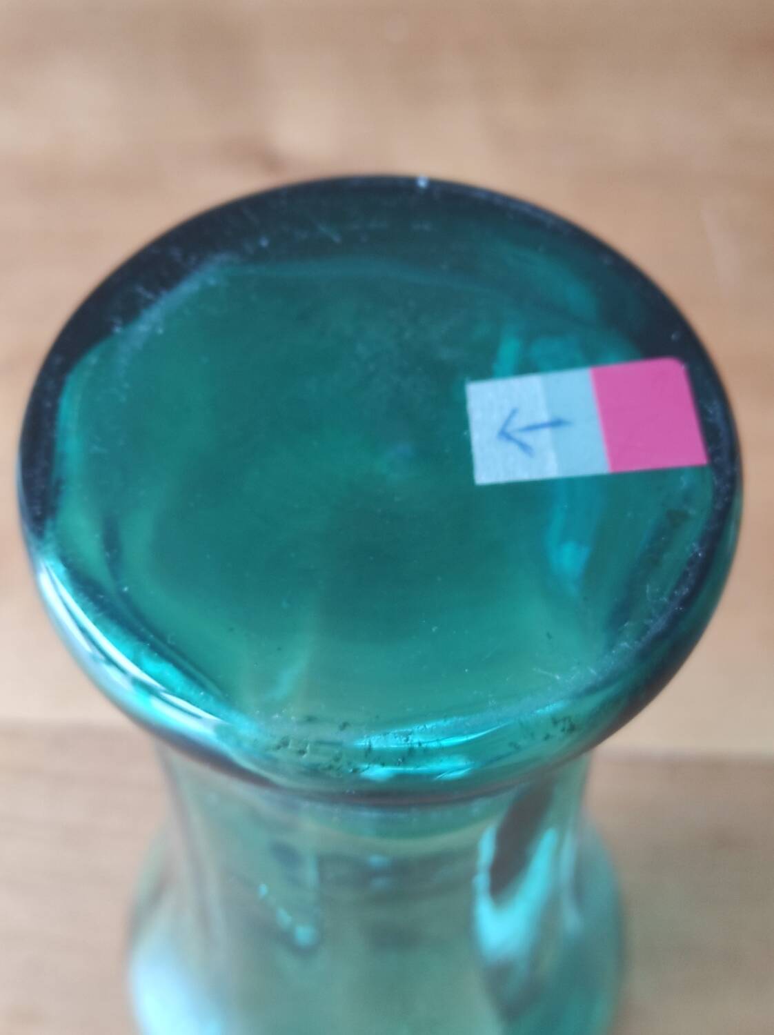 Blown glass vase with a flared neck and wavy rim.