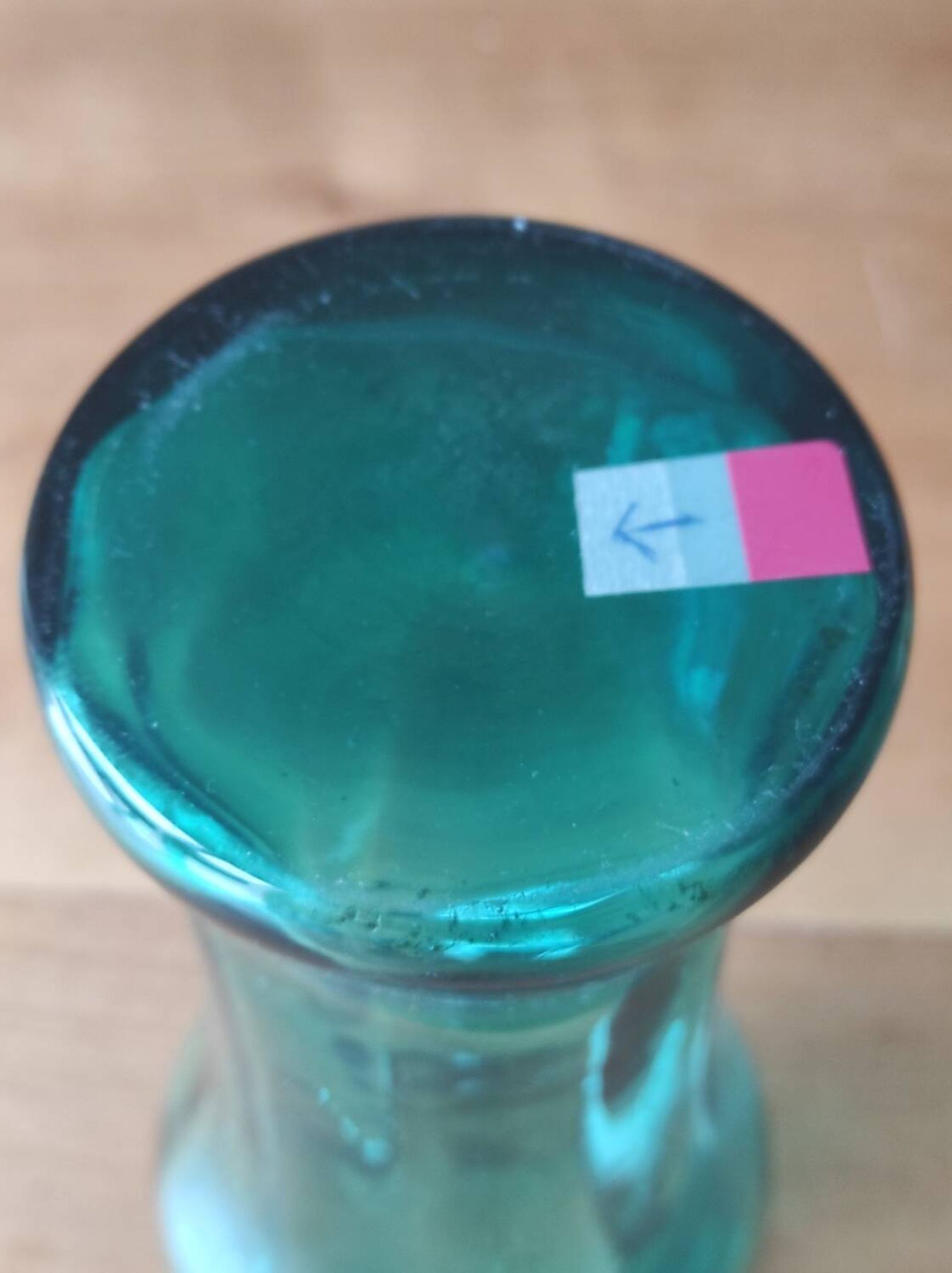 Blown glass vase with a flared neck and wavy rim.