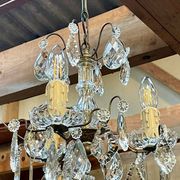 Three-light chandelier in bronze and cut crystal, early 20th century work.