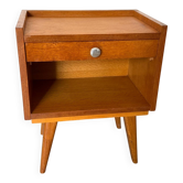 Vintage bedside table with tapered legs.