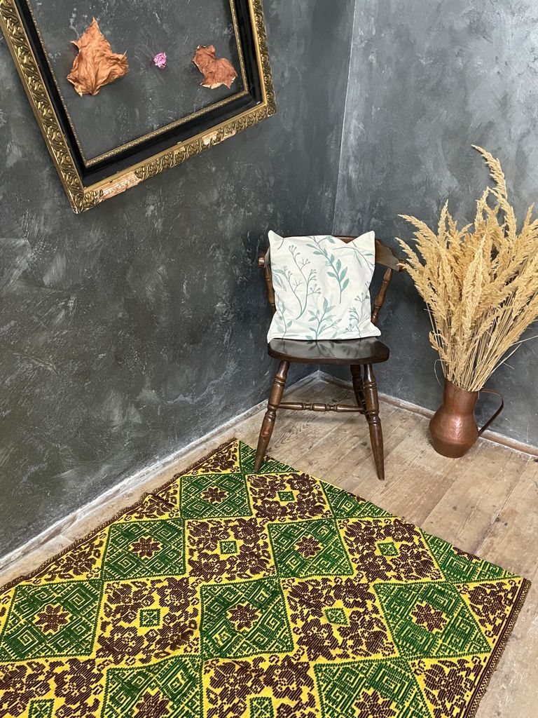 Green and yellow handmade rug with delicate colourful flowers