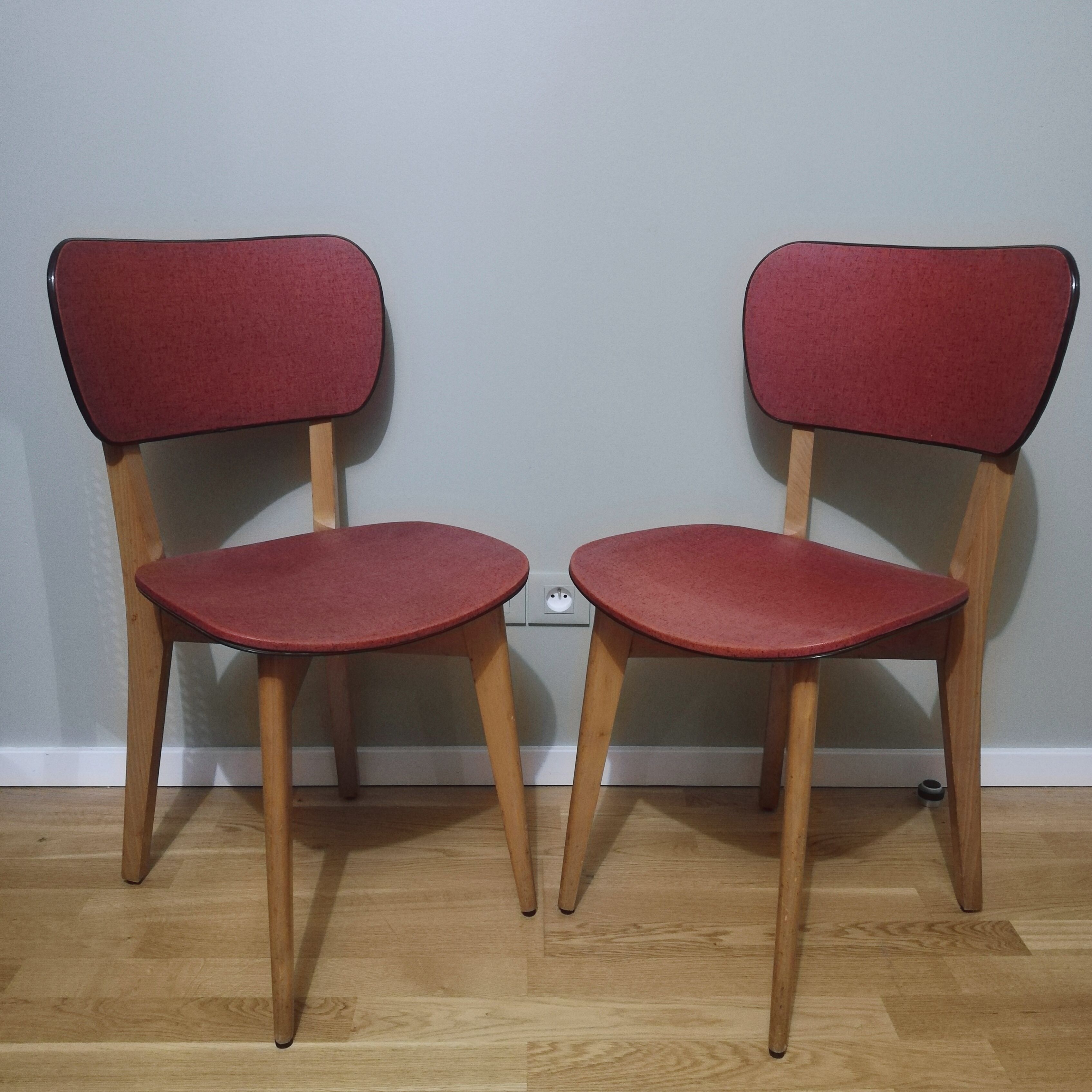 Two vintage chairs wood and mottled red vinyl