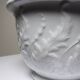Antique cache-pot in Limoges porcelain with a relief decoration of foliage.