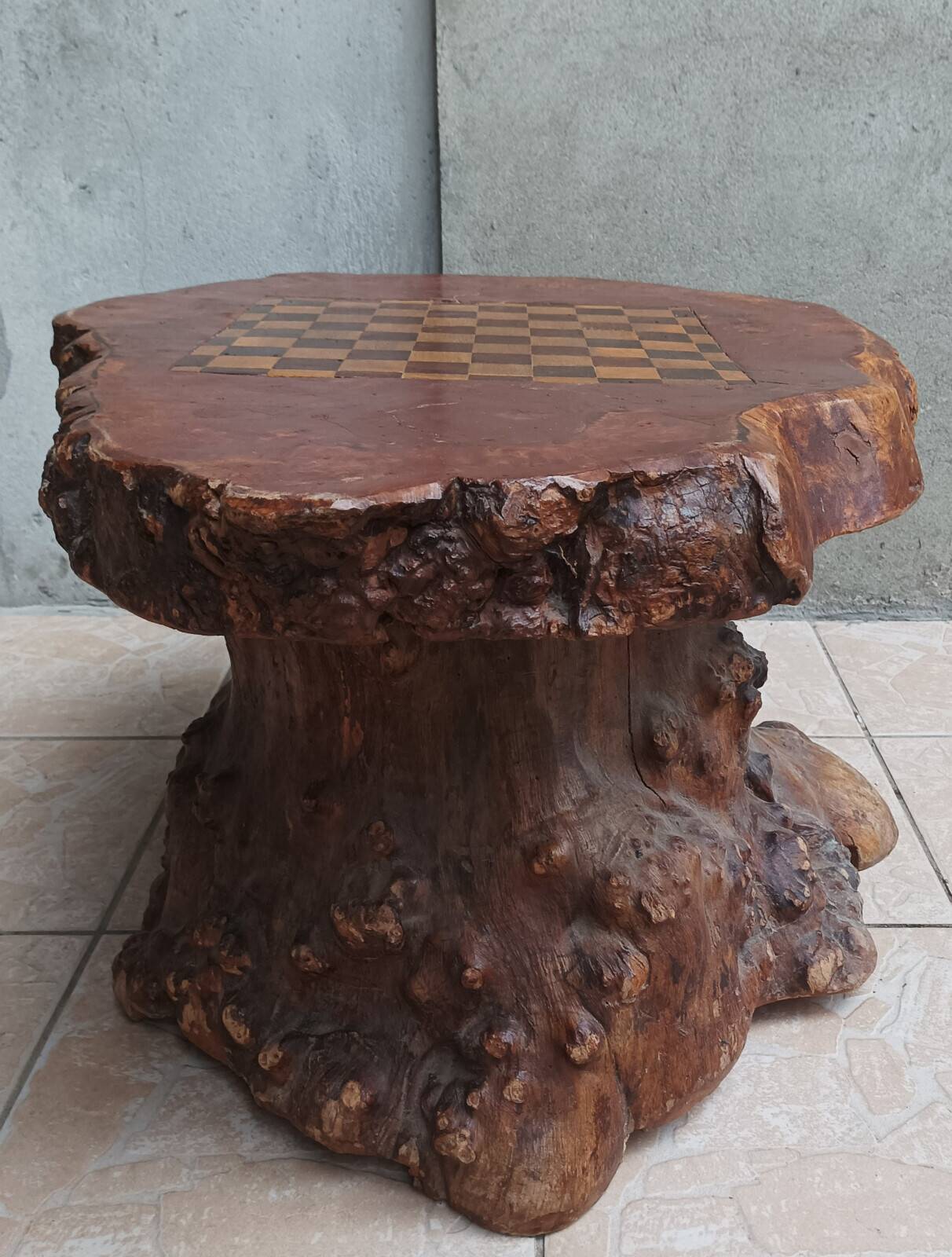 Brutalist chessboard coffee table made from tree stump.