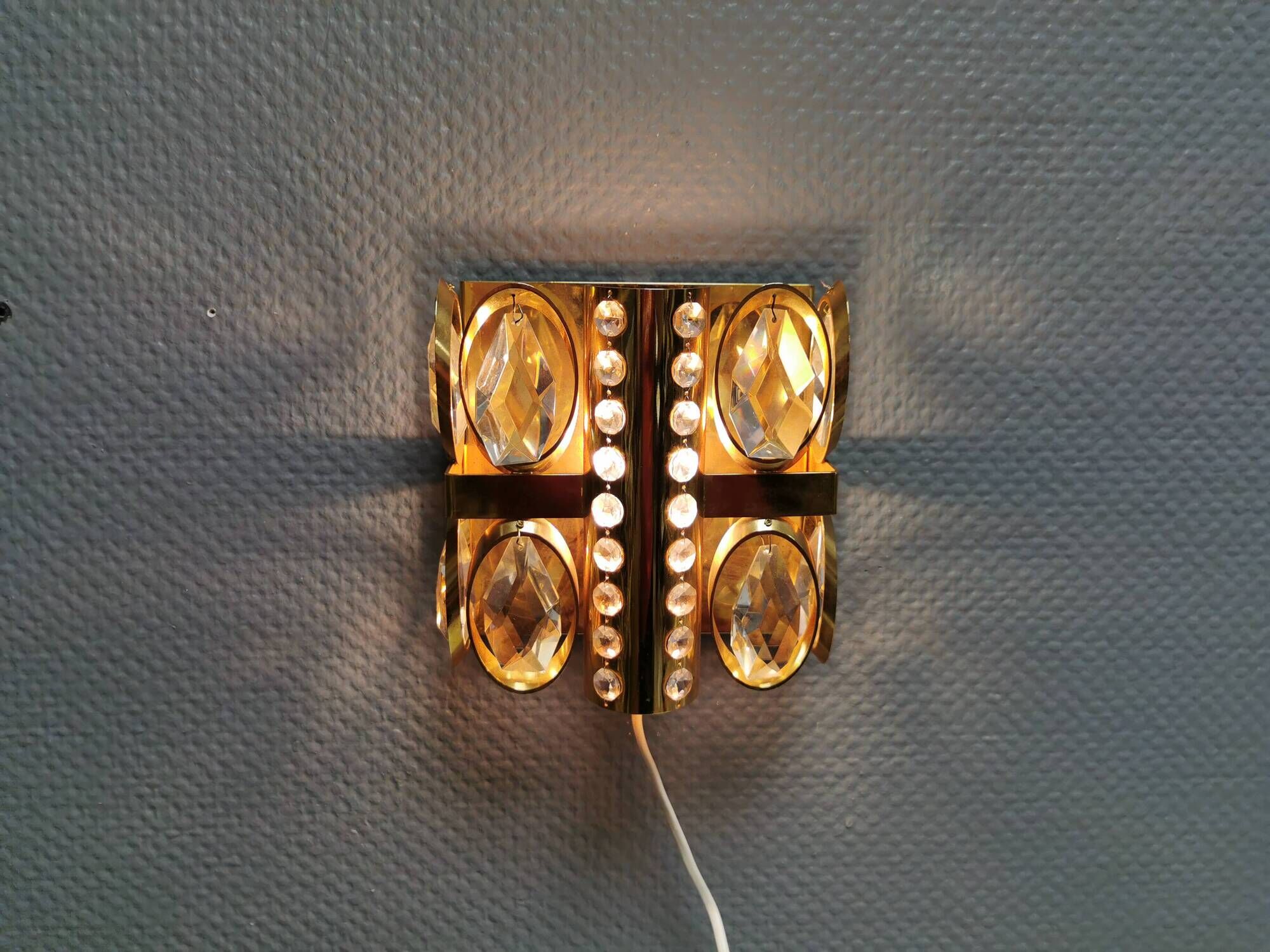 Swedish wall lamp in gold-colored metal with glass prisms. Estimated 1970-80s.