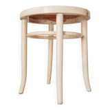 Antique stool with wood and cream caning.