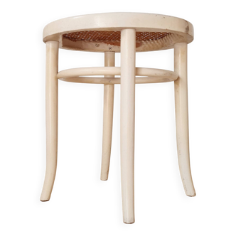 Antique stool with wood and cream caning.