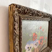Old painting of a bouquet of pansies and poppies.