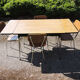 4 old chairs and an extendable table in 'faux wood' formica.