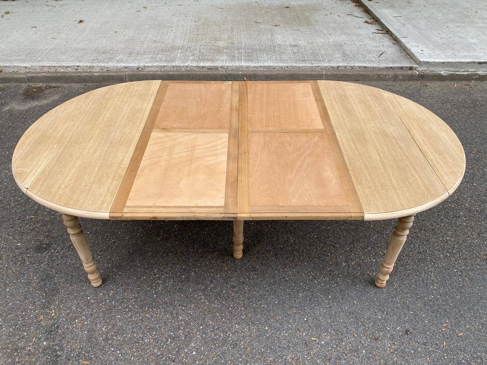 Round dining table with extendable leaves, Louis Philippe style, stripped in raw oak.