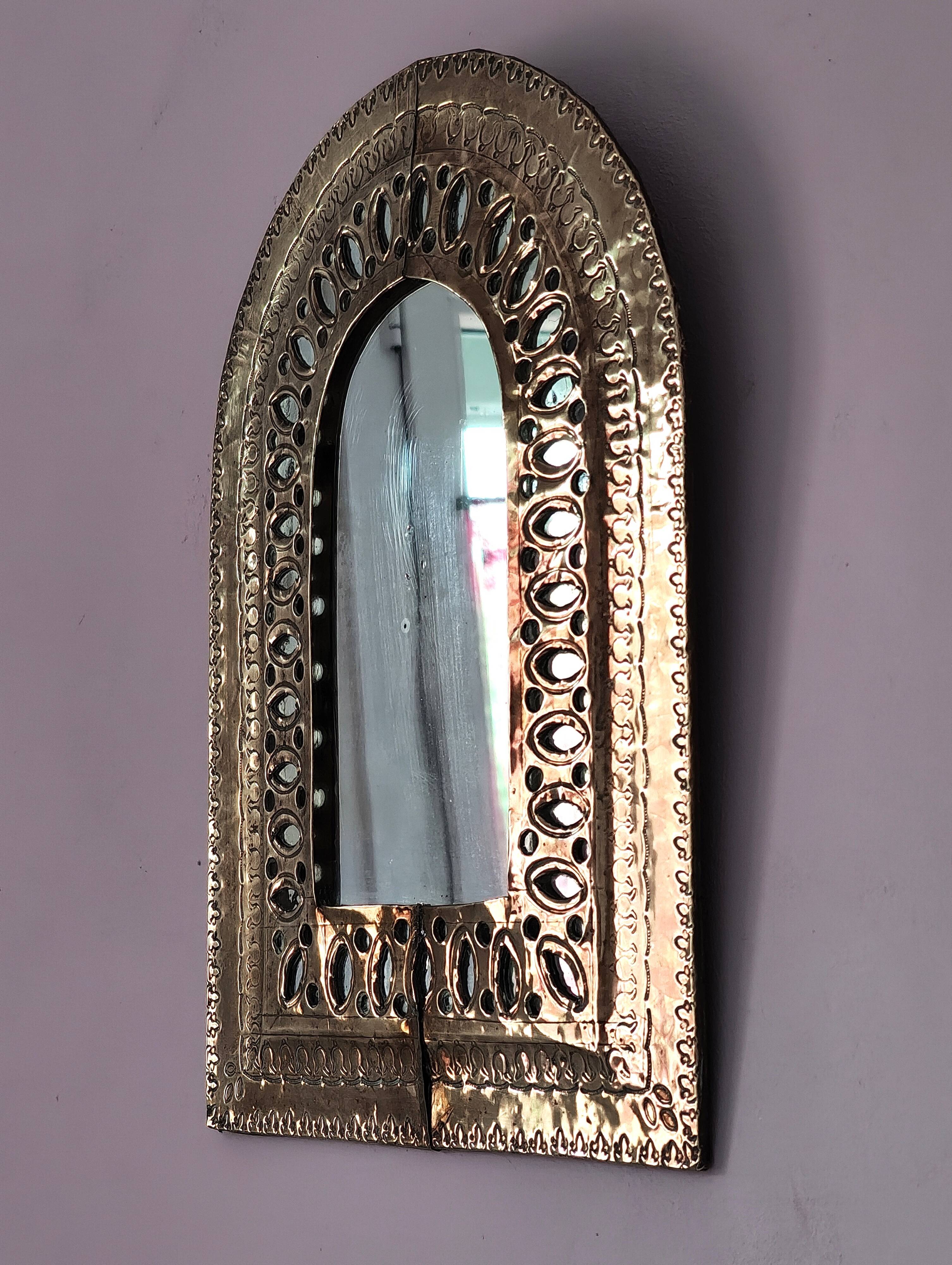 Small golden metal mirror in oriental style.