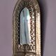 Small golden metal mirror in oriental style.