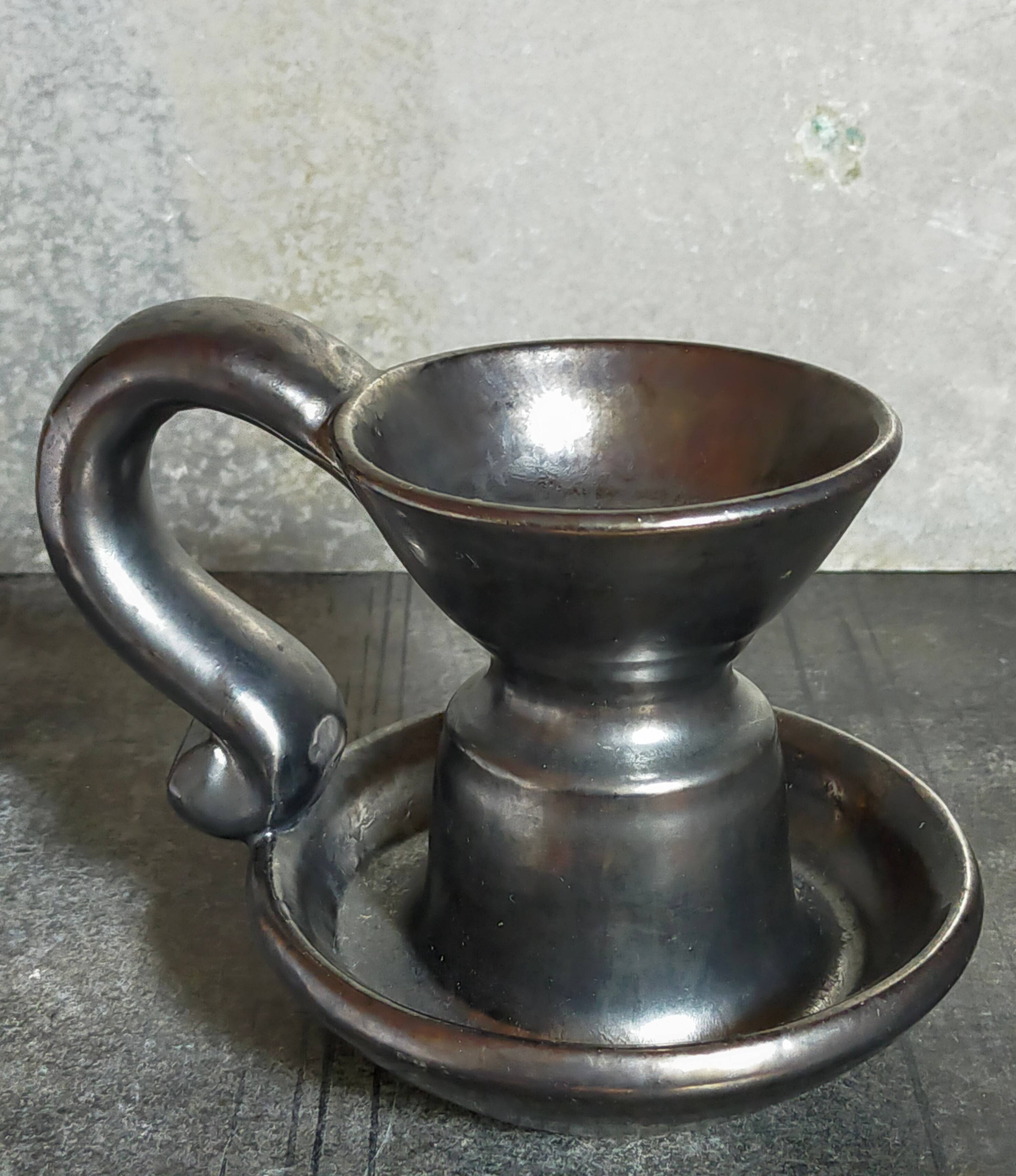 1950s iridescent black ceramic hand candle holder