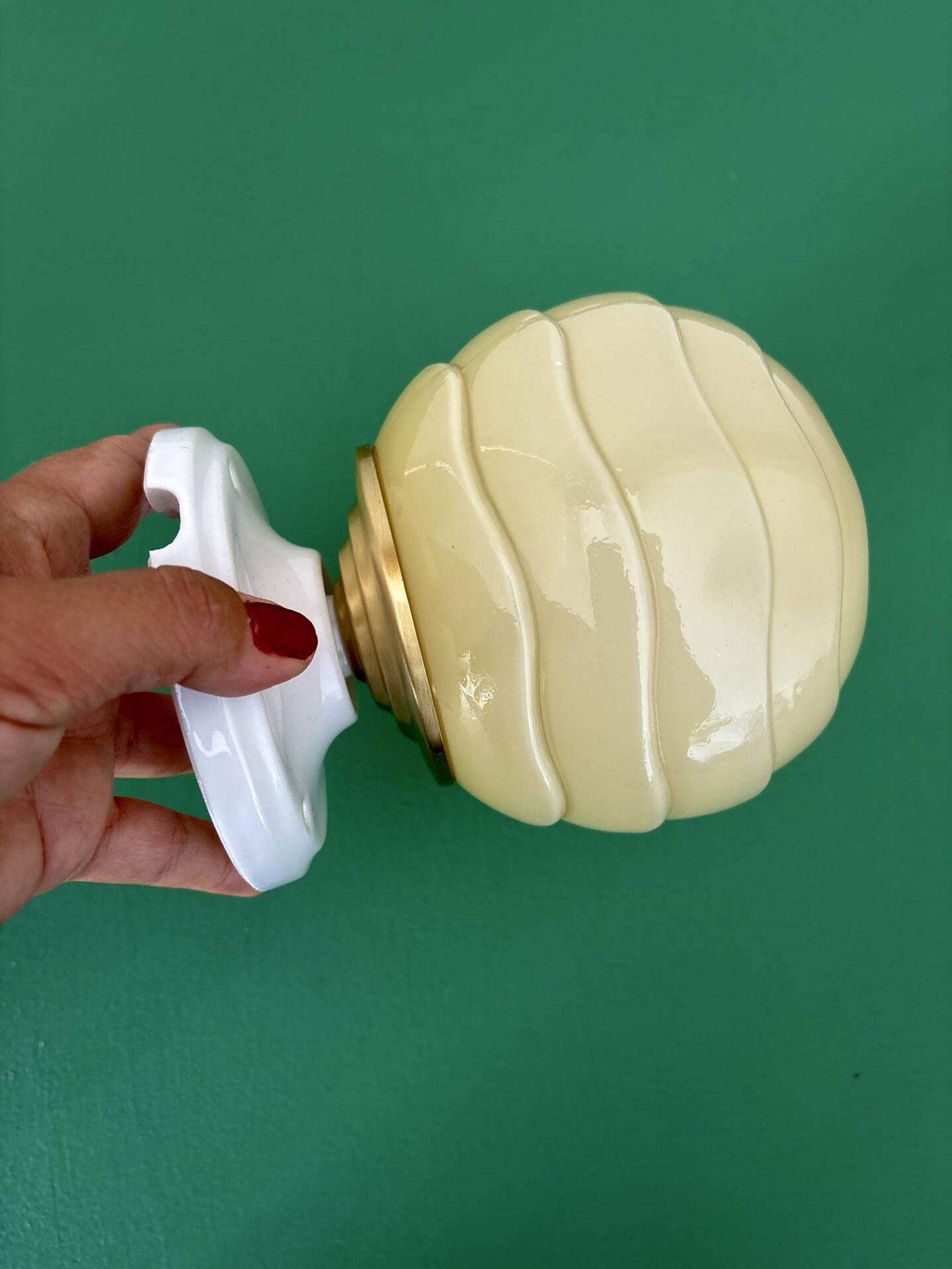 Vintage Art Deco globe wall light in pale yellow opaline.