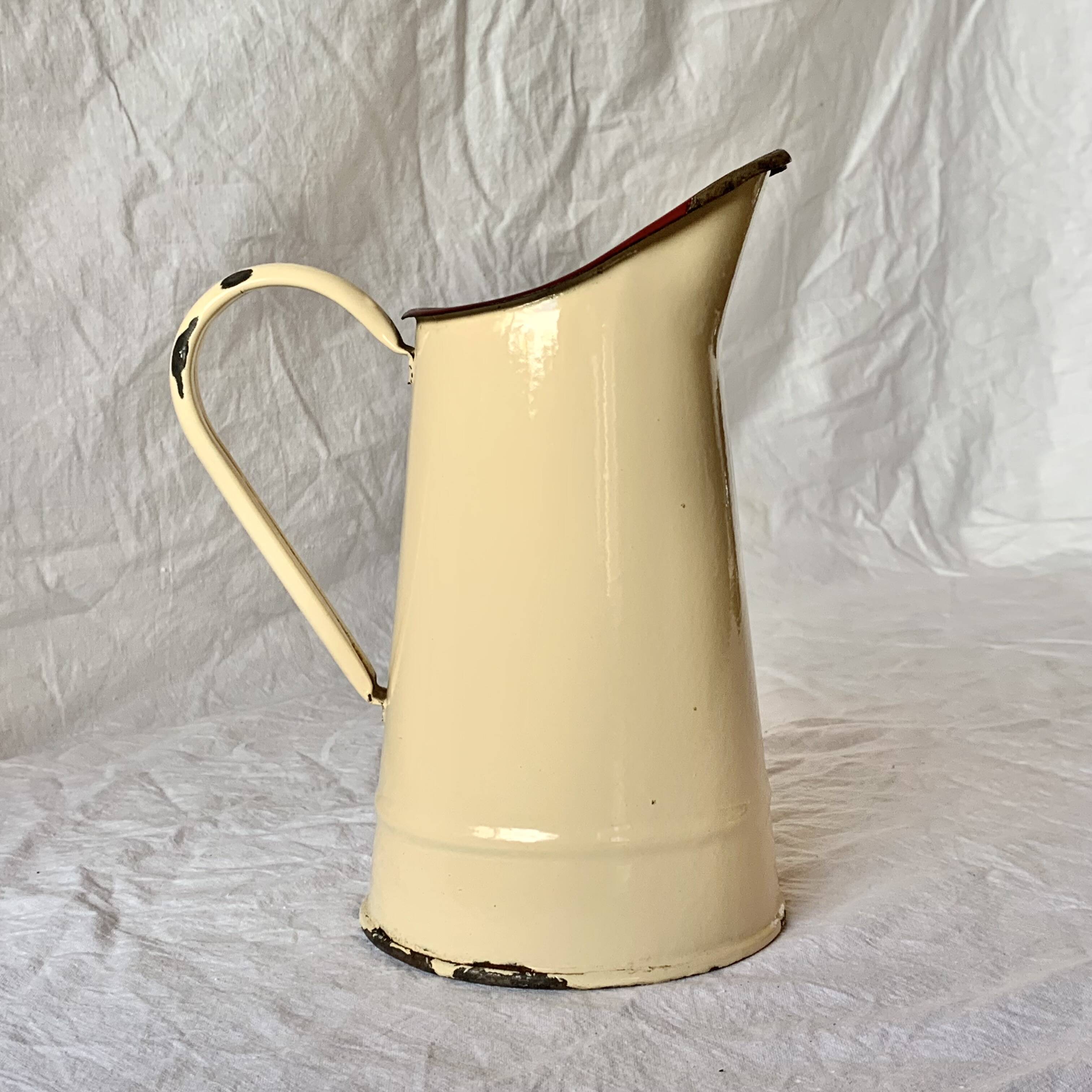 Vintage pitcher or jug in beige enamelled sheet metal