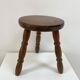 Old wooden tripod stool with ball feet